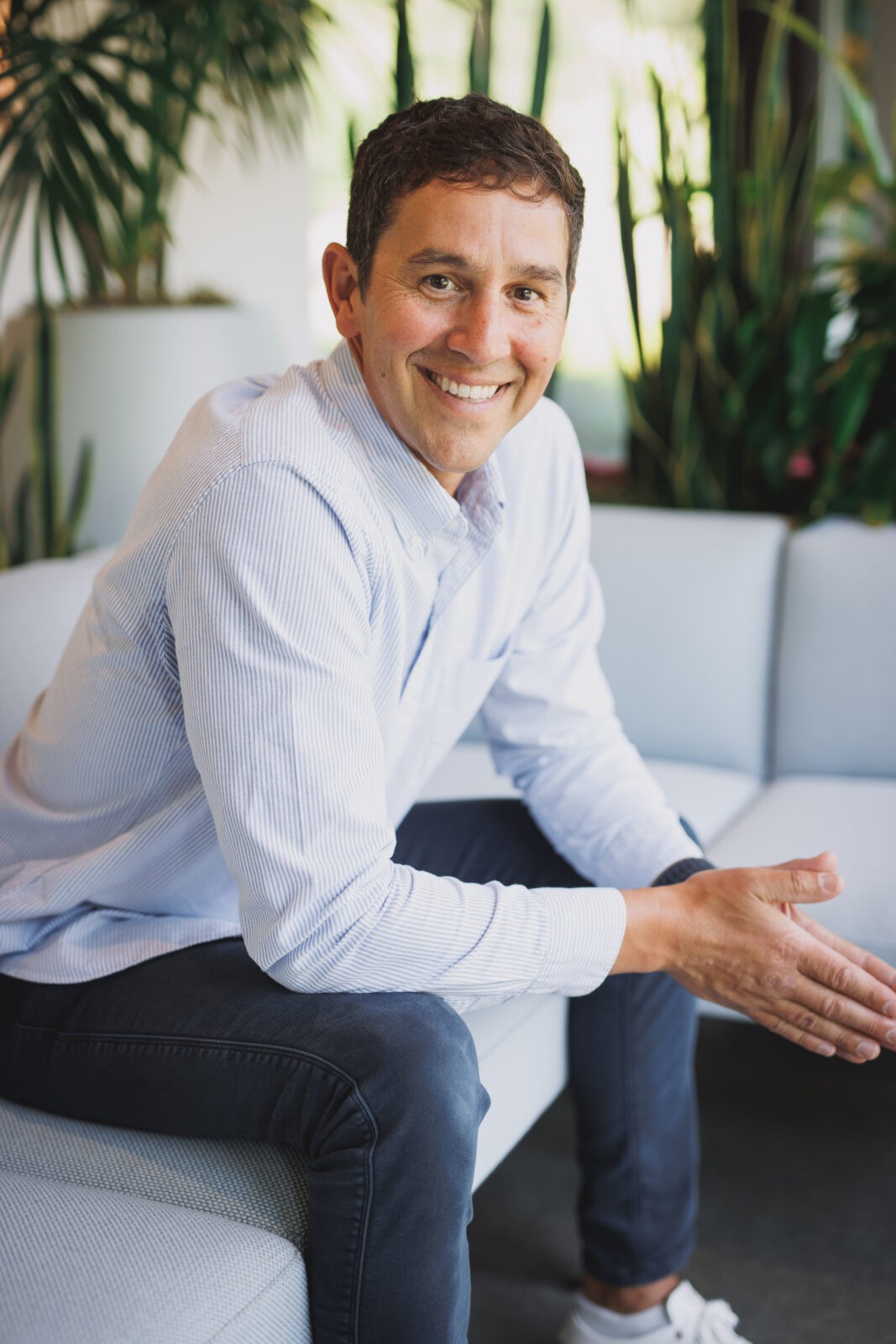 Professional Corporate headshot: Business man smiling in a casual business environment